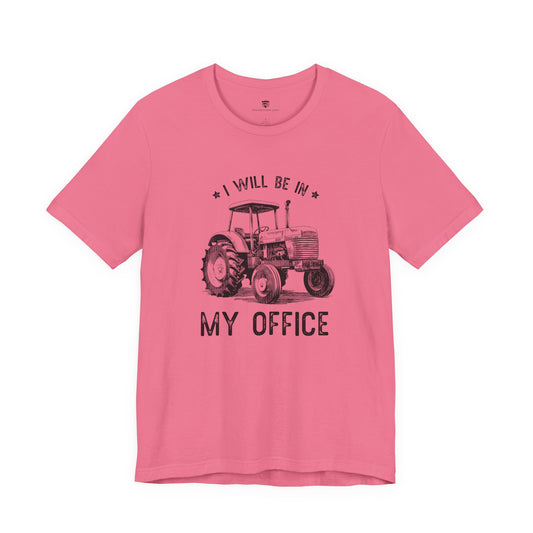 Pink t-shirt with a tractor graphic and text