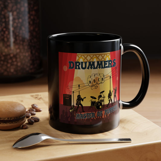 Black mug with a colorful design featuring 'DRUMMERS ROCK' on a wooden surface with coffee beans and a spoon.