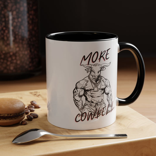 Mug with a graphic of a muscular figure and text on a wooden surface with coffee beans and a spoon.