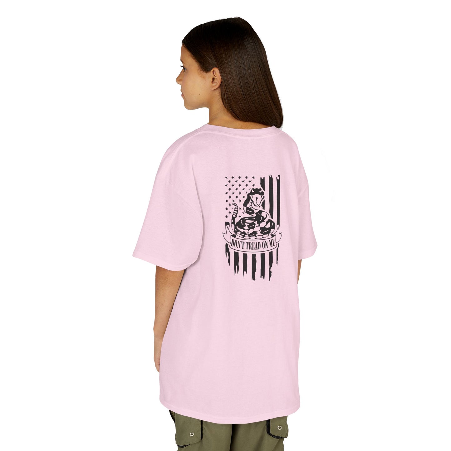 Person wearing a pink t-shirt with text on the back, standing against a white background