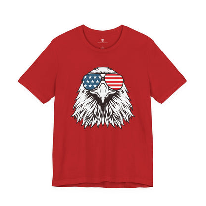 Red t-shirt with an eagle design wearing American flag sunglasses on a white background