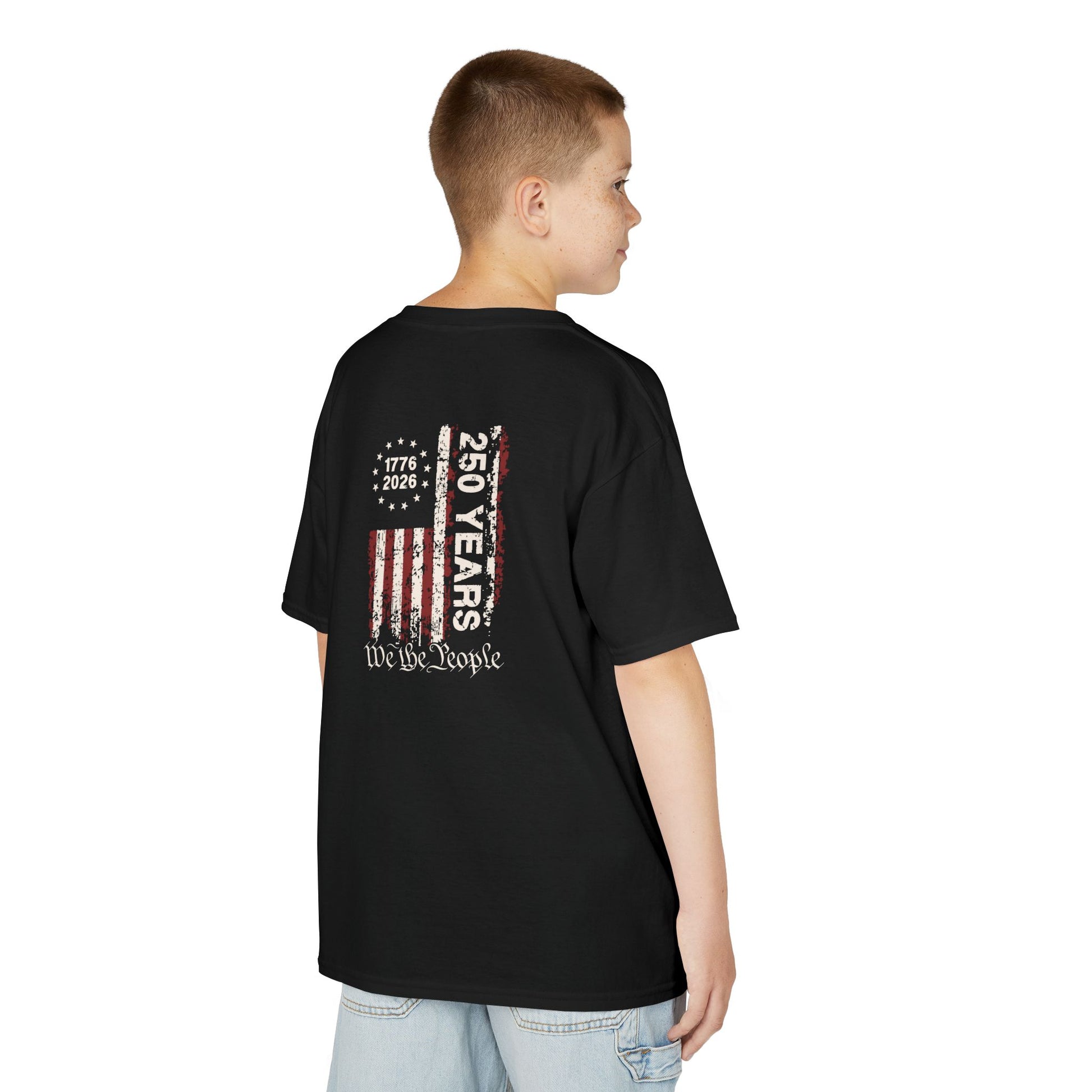 Child wearing a black t-shirt with a colorful graphic on the back, standing against a white background.