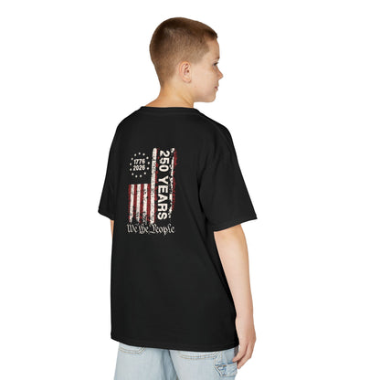 Child wearing a black t-shirt with a colorful graphic on the back, standing against a white background.