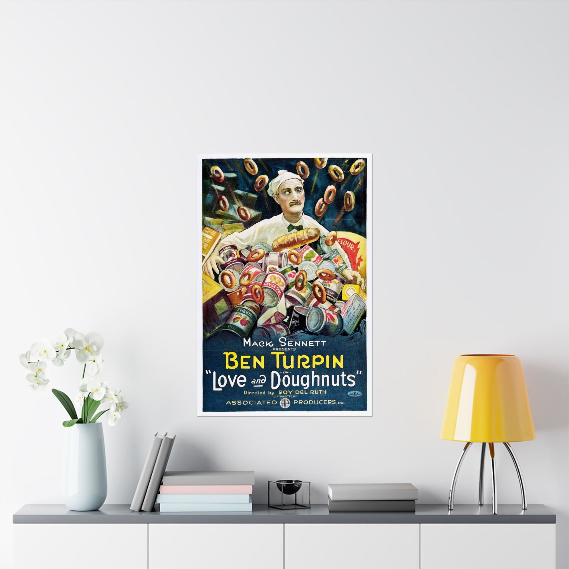 Vintage-style movie poster of Ben Turpin with doughnuts on a wall above a shelf with decor items.
