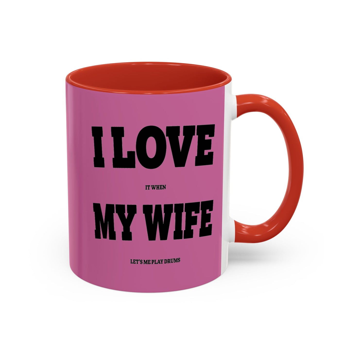 Pink mug with red interior and handle, featuring text on a white background