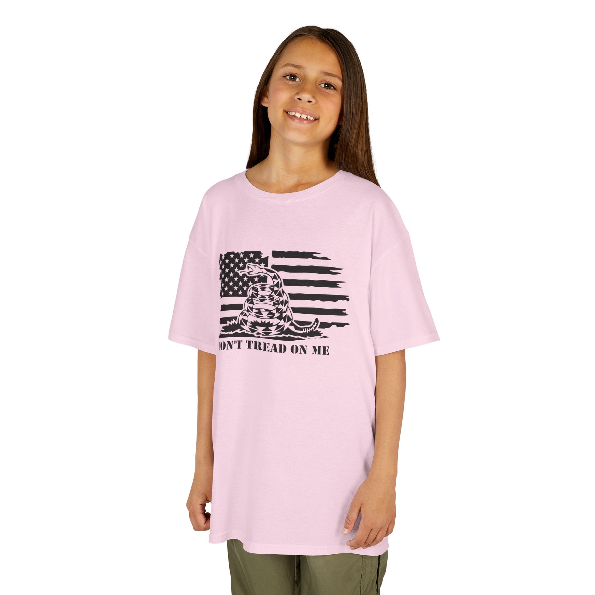 Young girl wearing a pink t-shirt with a graphic design on a white background
