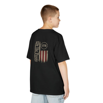 Child wearing a black t-shirt with a quote on the back, standing against a white background