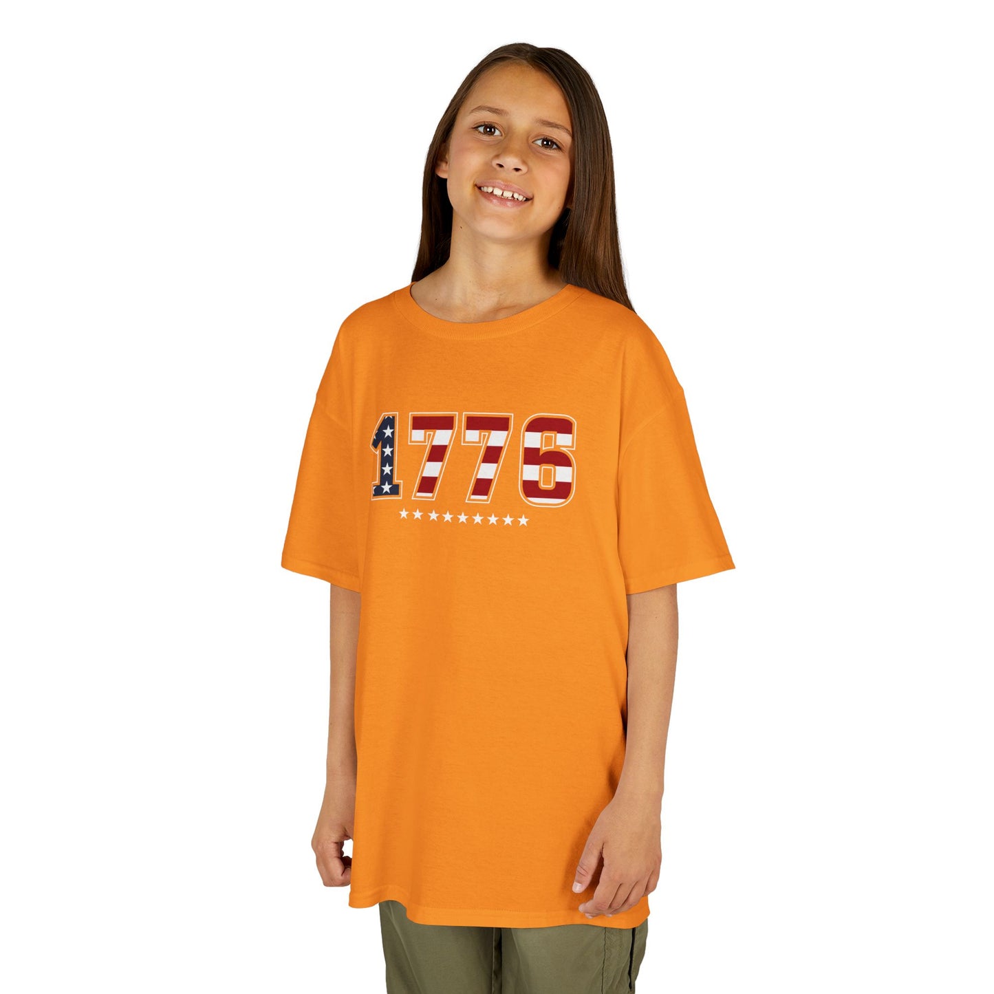 Child wearing an orange t-shirt with '1776' design on a white background