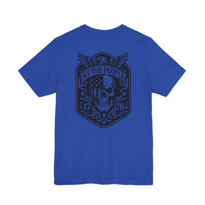 Blue t-shirt with a black graphic design on the back featuring a skull and text.