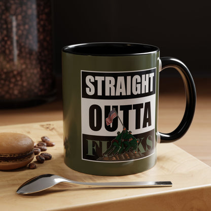 Mug with 'Straight Outta' design on a wooden surface with coffee beans and a macaron.