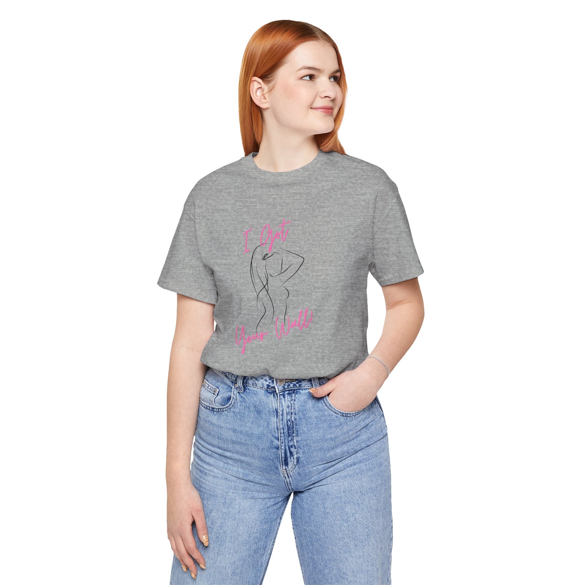 Person wearing a gray t-shirt with text and graphics, standing against a white background