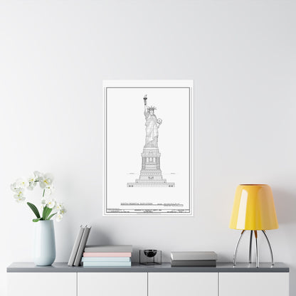 Framed black and white print of the Statue of Liberty on a wall above a desk with decor items.