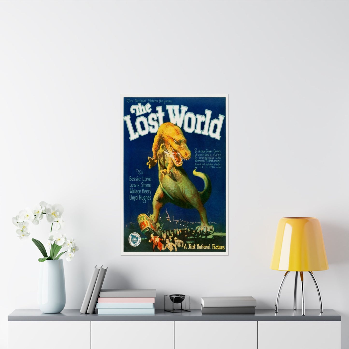 Vintage 'The Lost World' movie poster on a wall above a shelf with decor items.