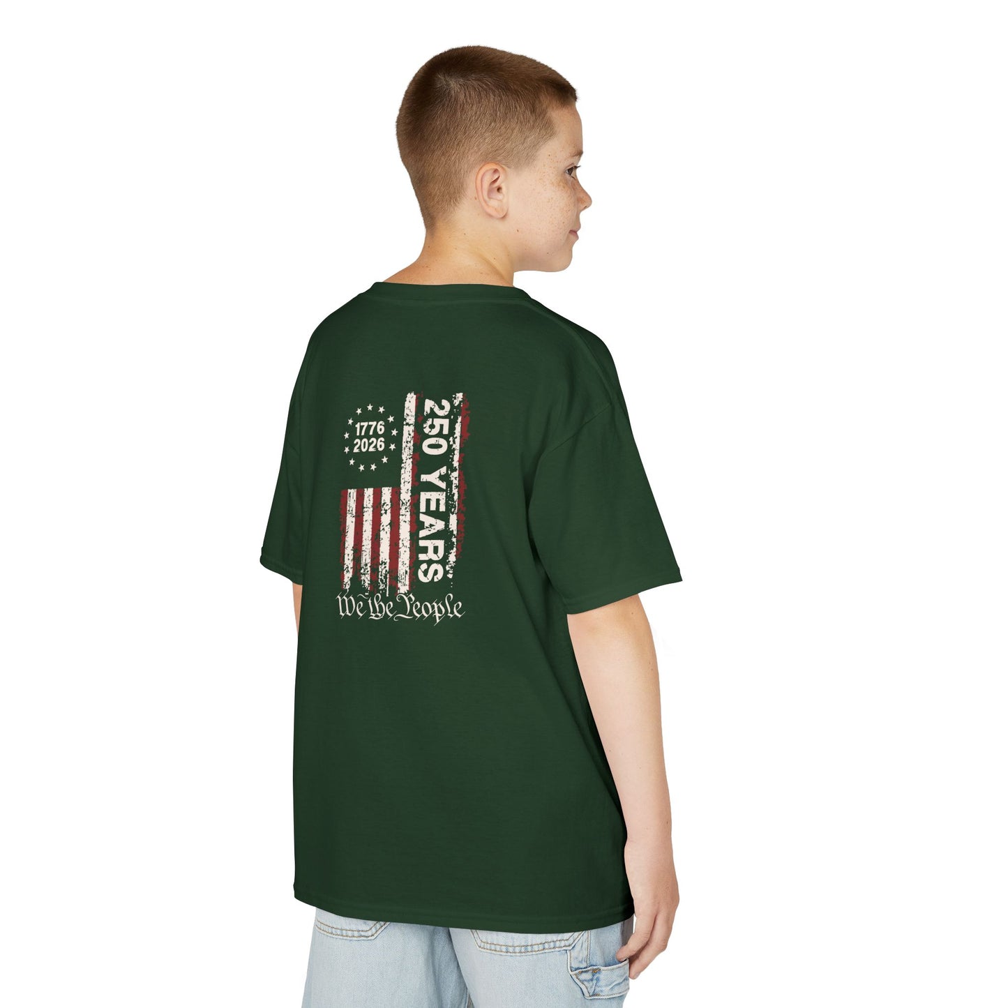 Child wearing a green t-shirt with a graphic design on the back, standing against a white background
