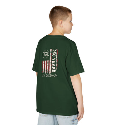 Child wearing a green t-shirt with a graphic design on the back, standing against a white background