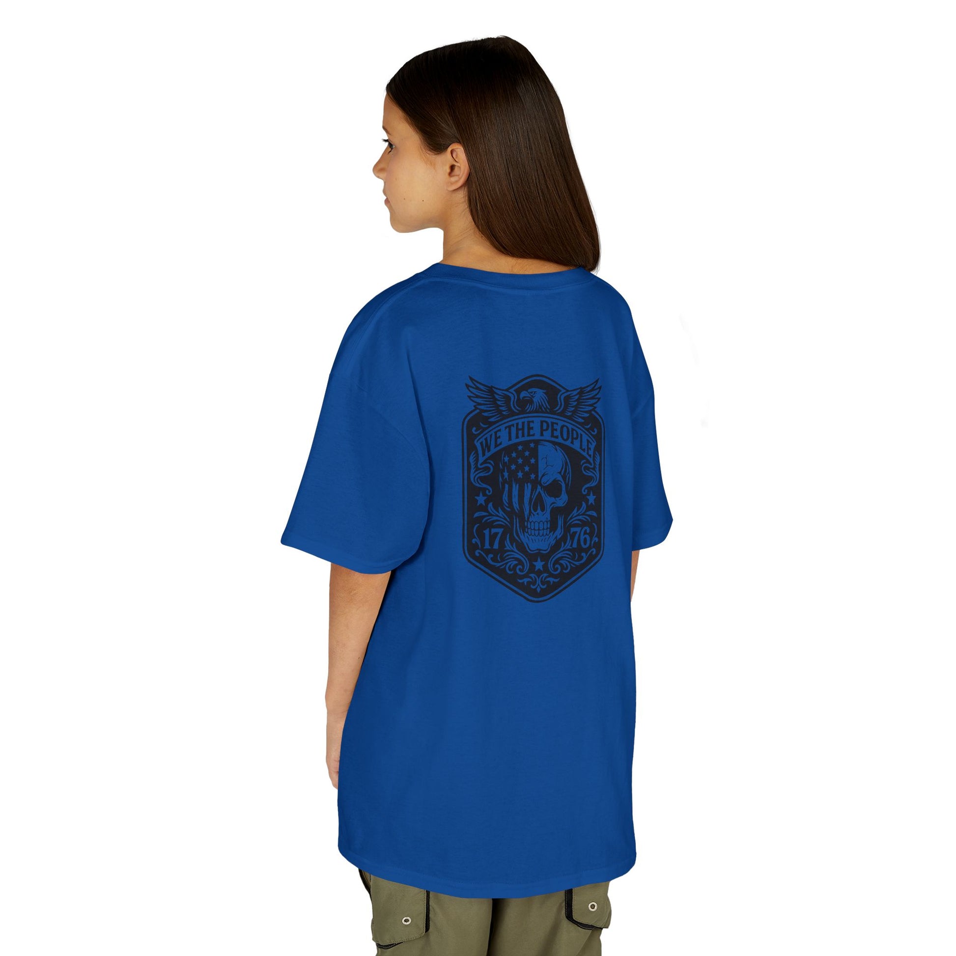 Person wearing a blue t-shirt with a graphic design on the back, standing against a white background
