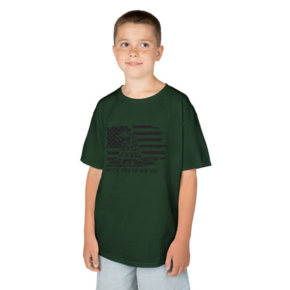 Child wearing a green t-shirt with a graphic design on a white background