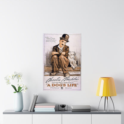Poster of Charlie Chaplin and a dog on a wall above a shelf with books and a lamp.