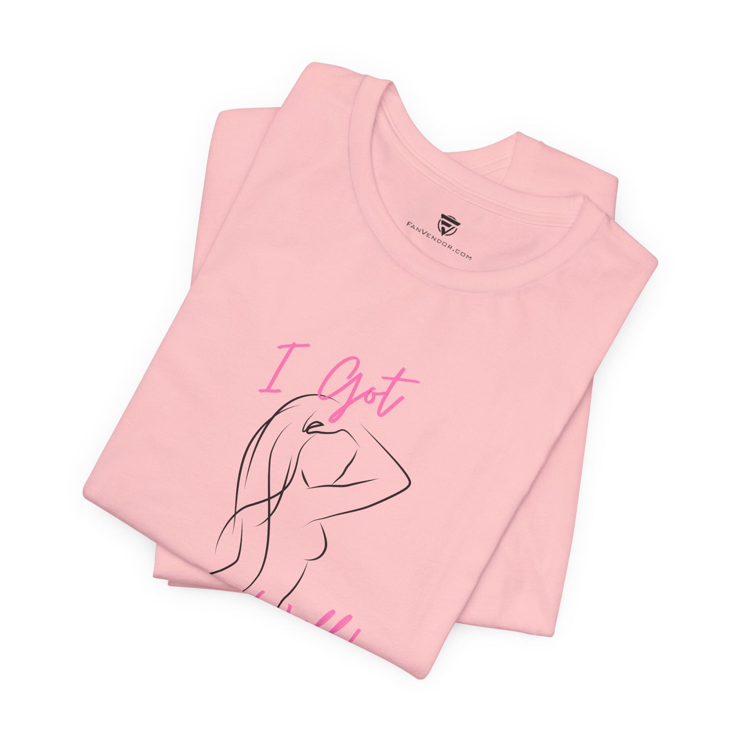 Folded pink t-shirt with 'I Got' text and a line drawing on a white background