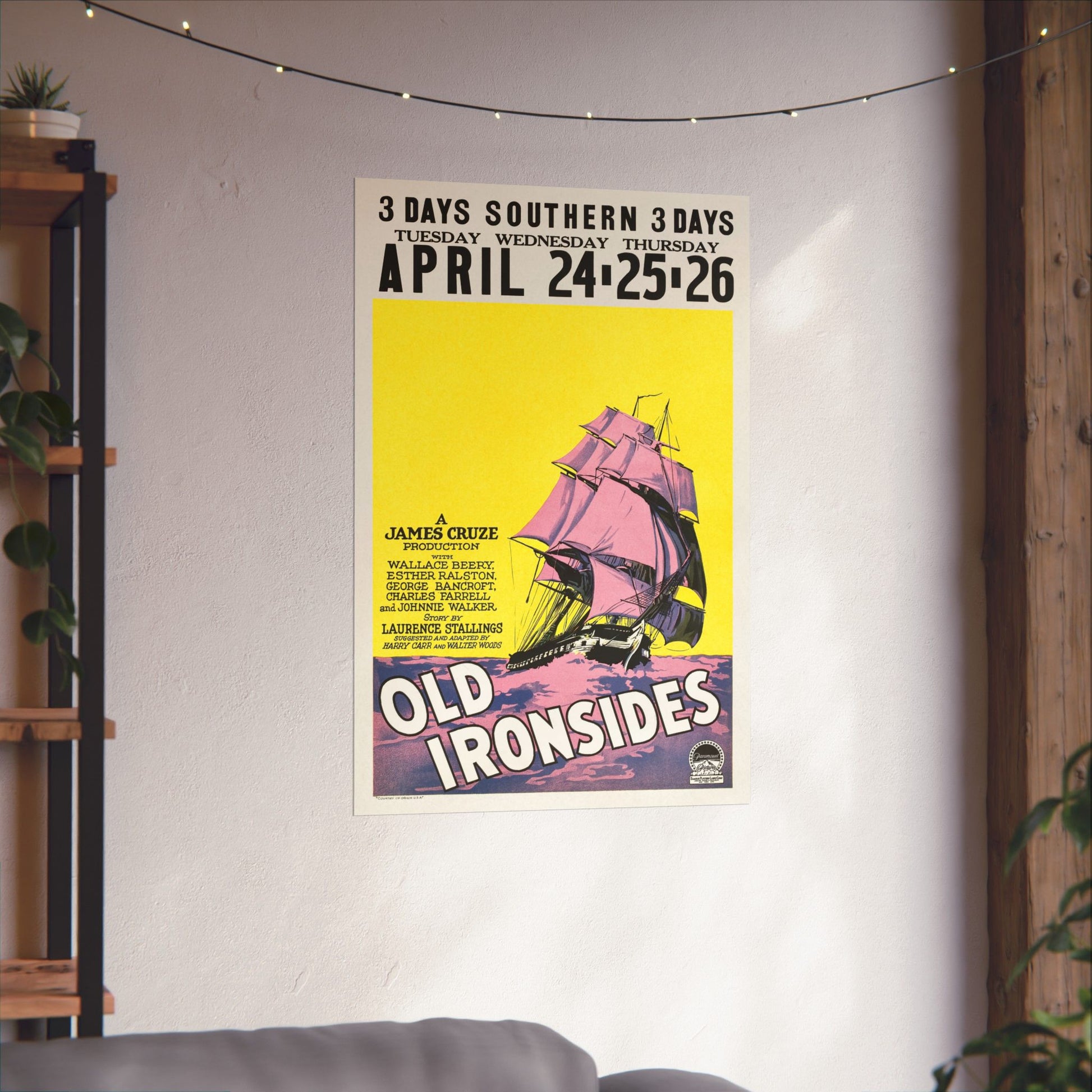 Poster for 'Old Ironsides' event with ship illustration on a wall in a room.