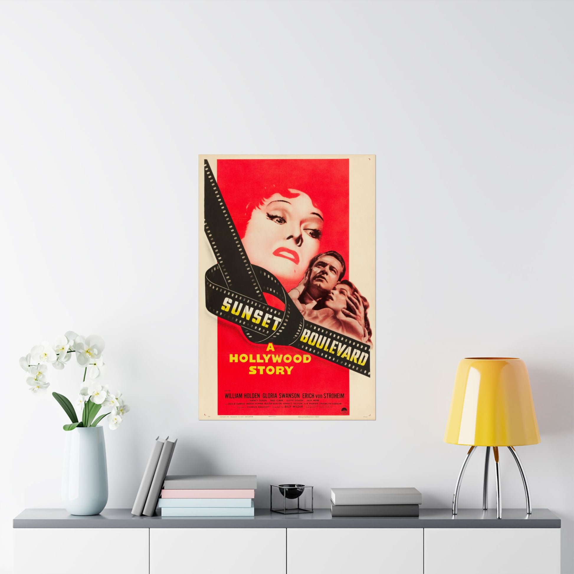 Movie poster for 'Sunset Boulevard' on a wall above a shelf with decor items.