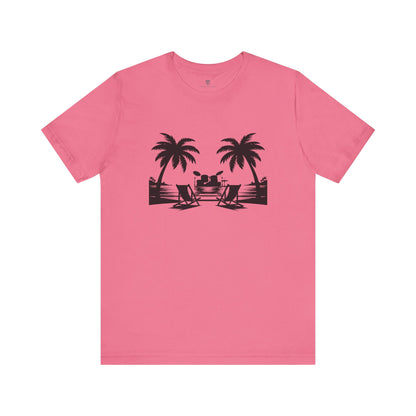 Pink t-shirt with black beach graphic on a white background