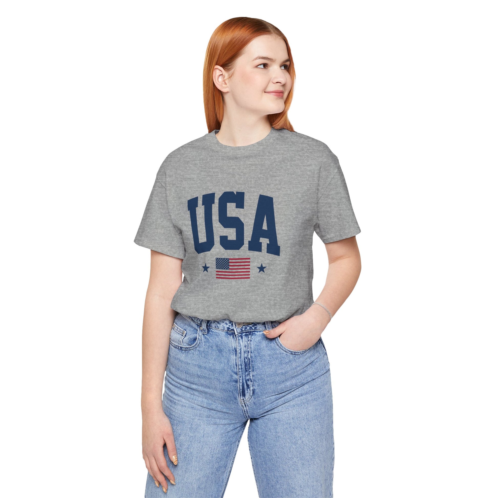Person wearing a gray t-shirt with 'USA' and an American flag design on a white background
