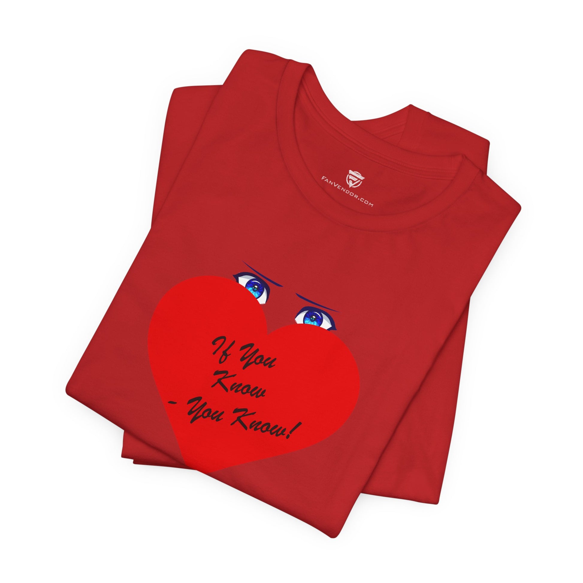 Folded red t-shirt with a heart design and text on a white background