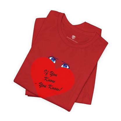 Folded red t-shirt with a heart design and text on a white background