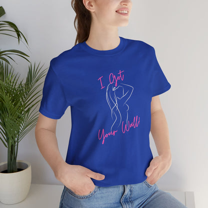 Person wearing a blue t-shirt with pink text and design, standing indoors.