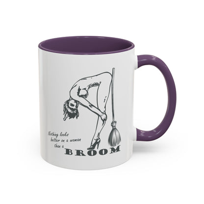 Mug with a graphic of a woman holding a broom and text, against a white background