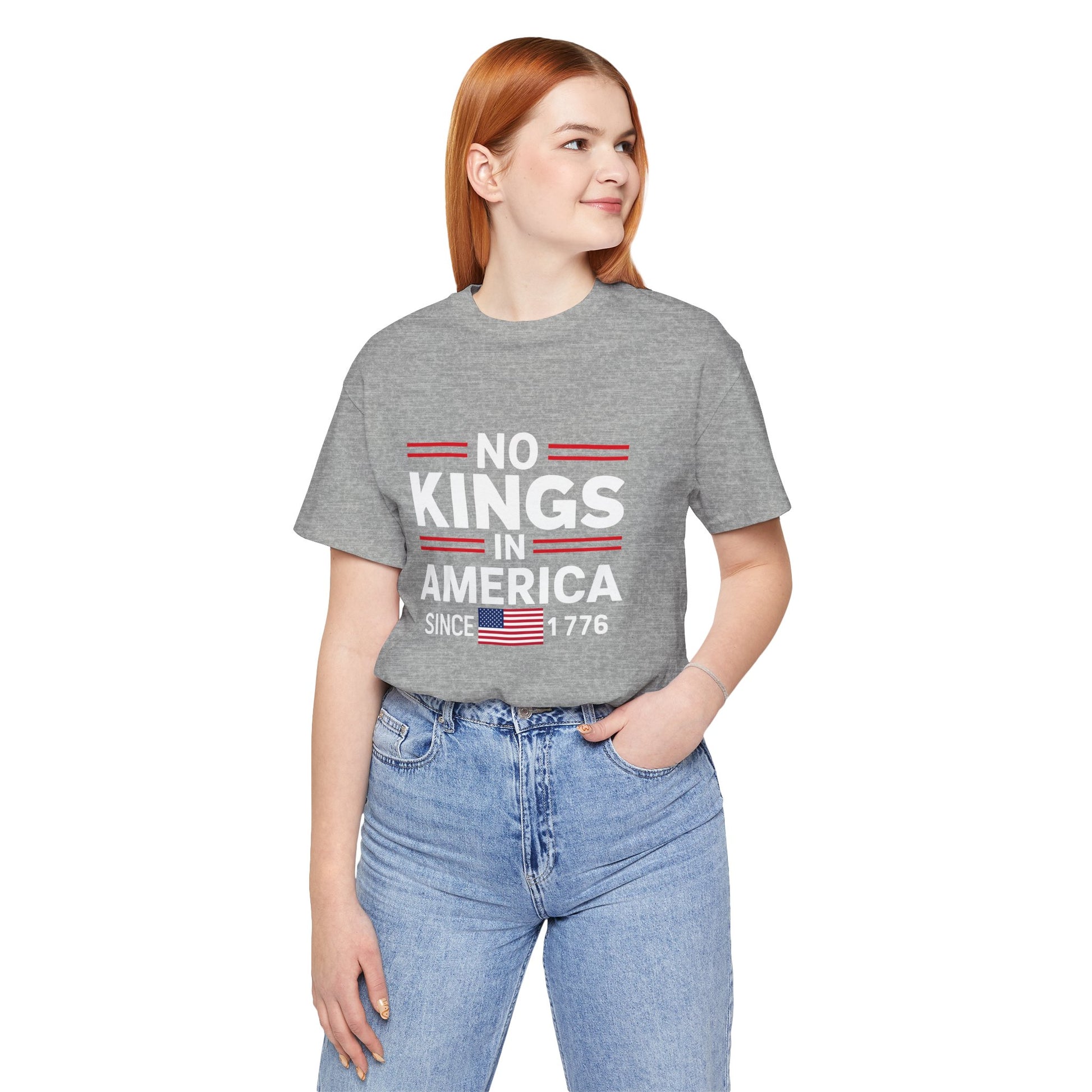 Person wearing a gray t-shirt with 'No Kings in America' text and an American flag graphic.
