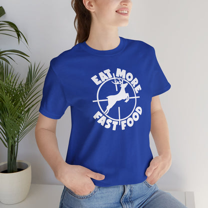 Person wearing a blue t-shirt with a graphic design and text, standing indoors.