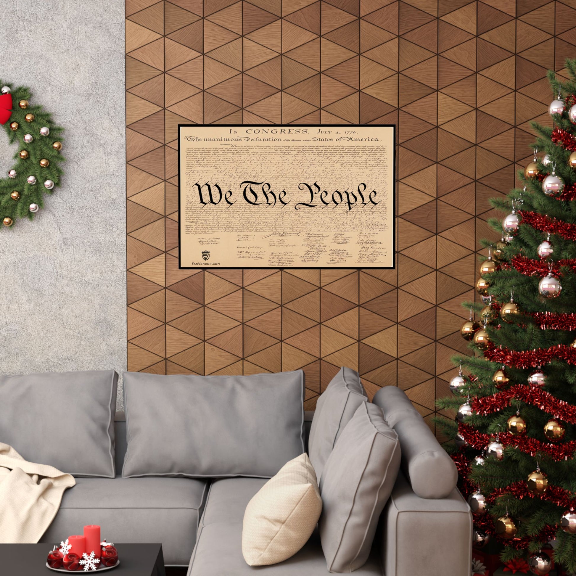 Living room with a gray sofa, Christmas tree, and framed document on the wall.