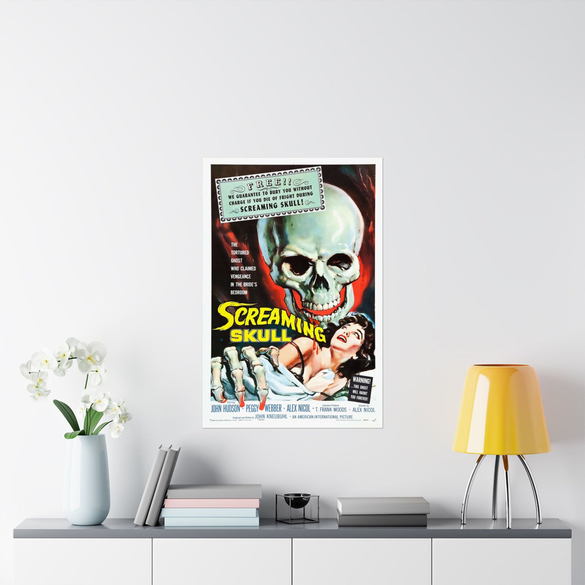 Vintage movie poster of 'The Screaming Skull' on a wall above a shelf with decor items.