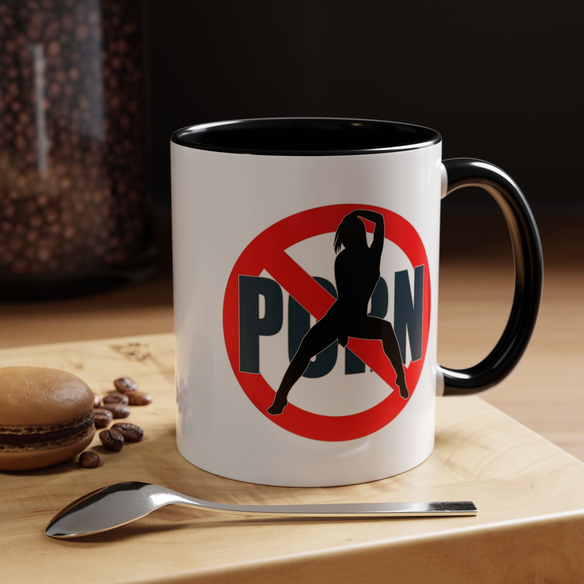 Mug with a no symbol on a wooden surface with coffee beans and a spoon.