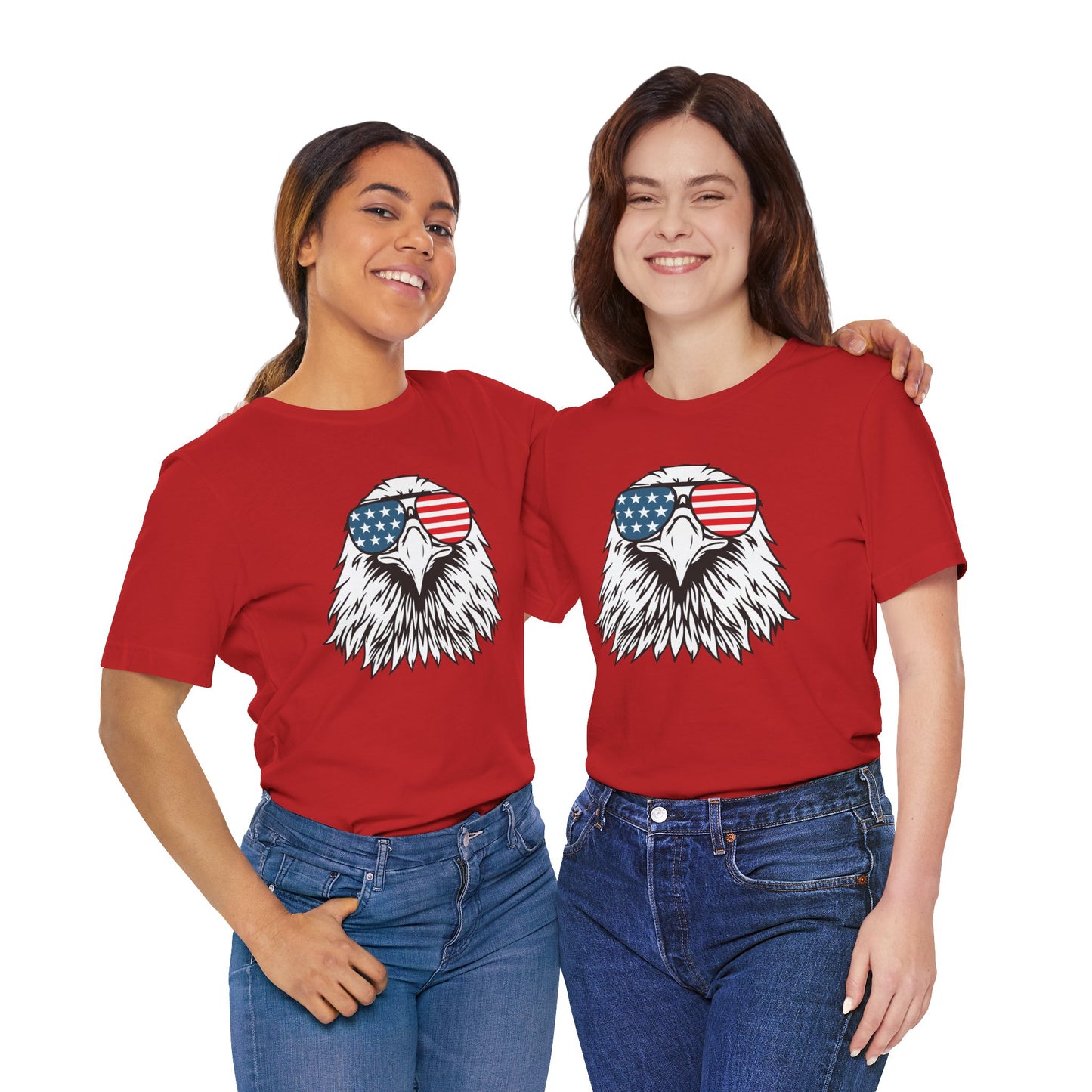 Two people wearing red t-shirts with an eagle graphic and American flag sunglasses on a white background.