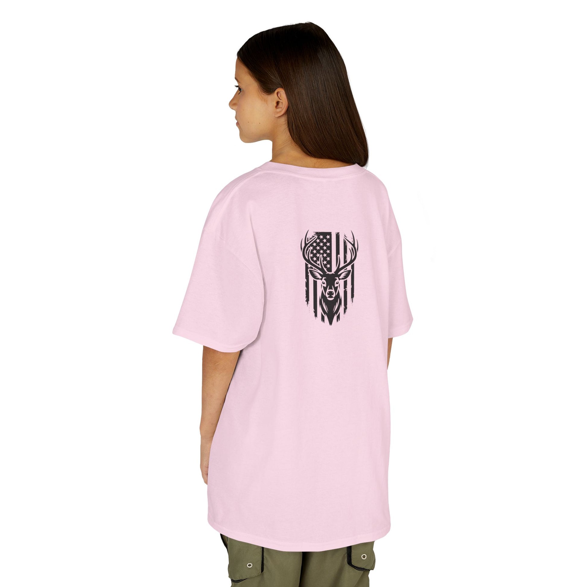 Person wearing a pink t-shirt with a black graphic design on the back, standing against a white background