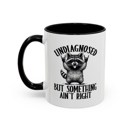 Mug with a raccoon graphic and text on a white background