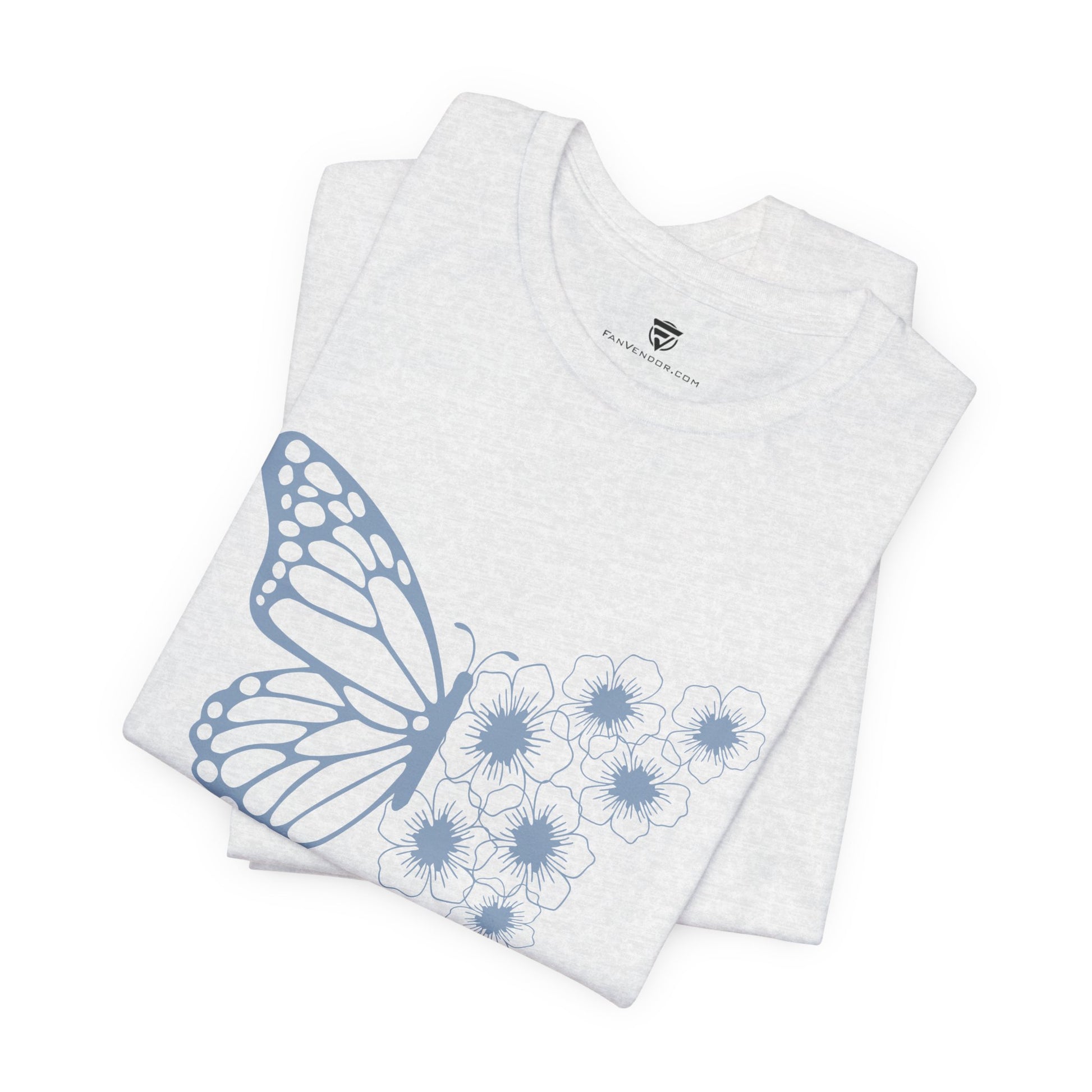 White t-shirt with blue butterfly and flower design on a white background