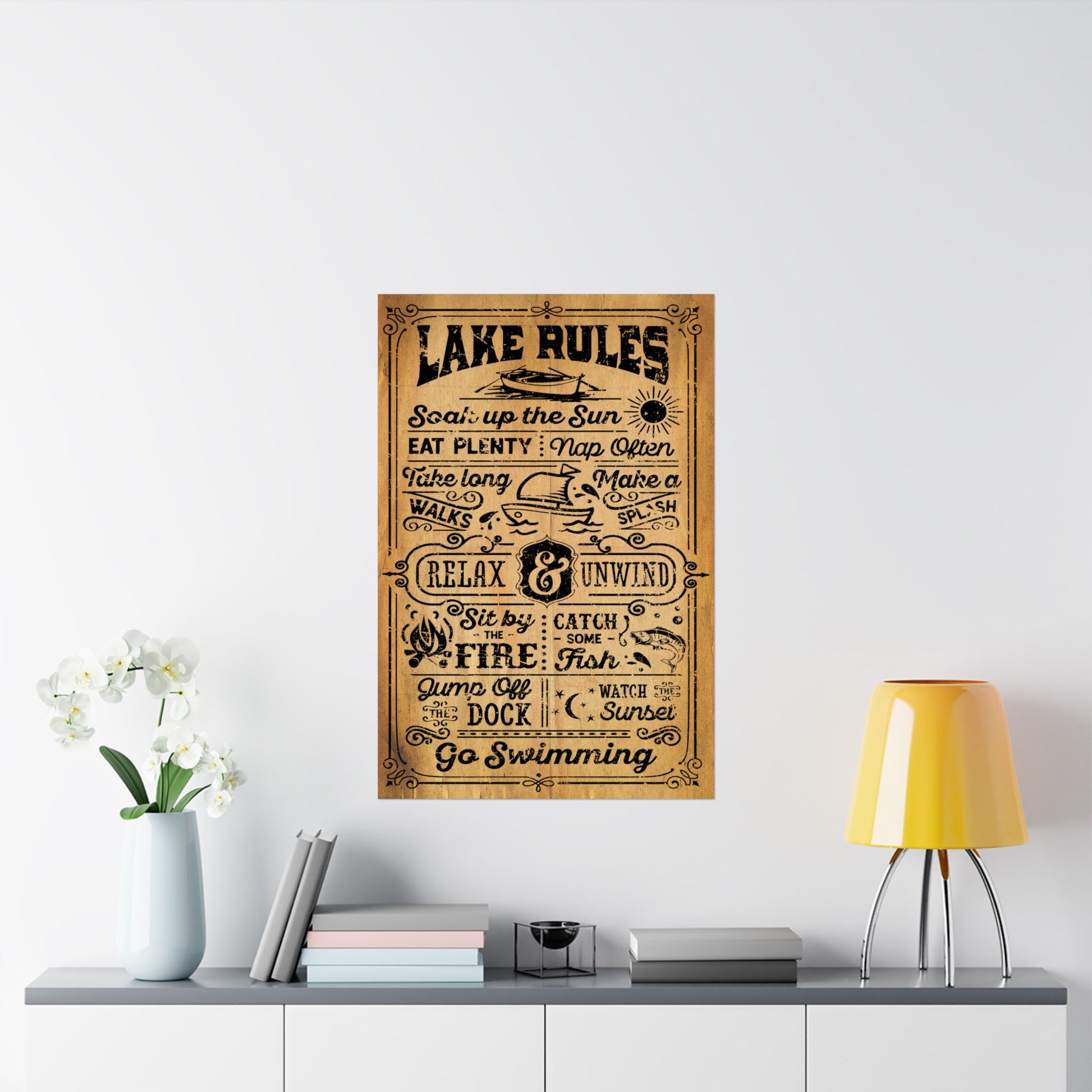 Wooden sign with 'Lake Rules' text on a wall above a shelf with decor items.