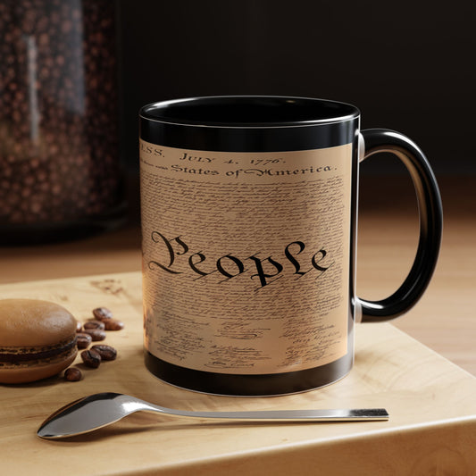Mug with a design resembling the U.S. Constitution on a wooden surface with coffee beans and a spoon.