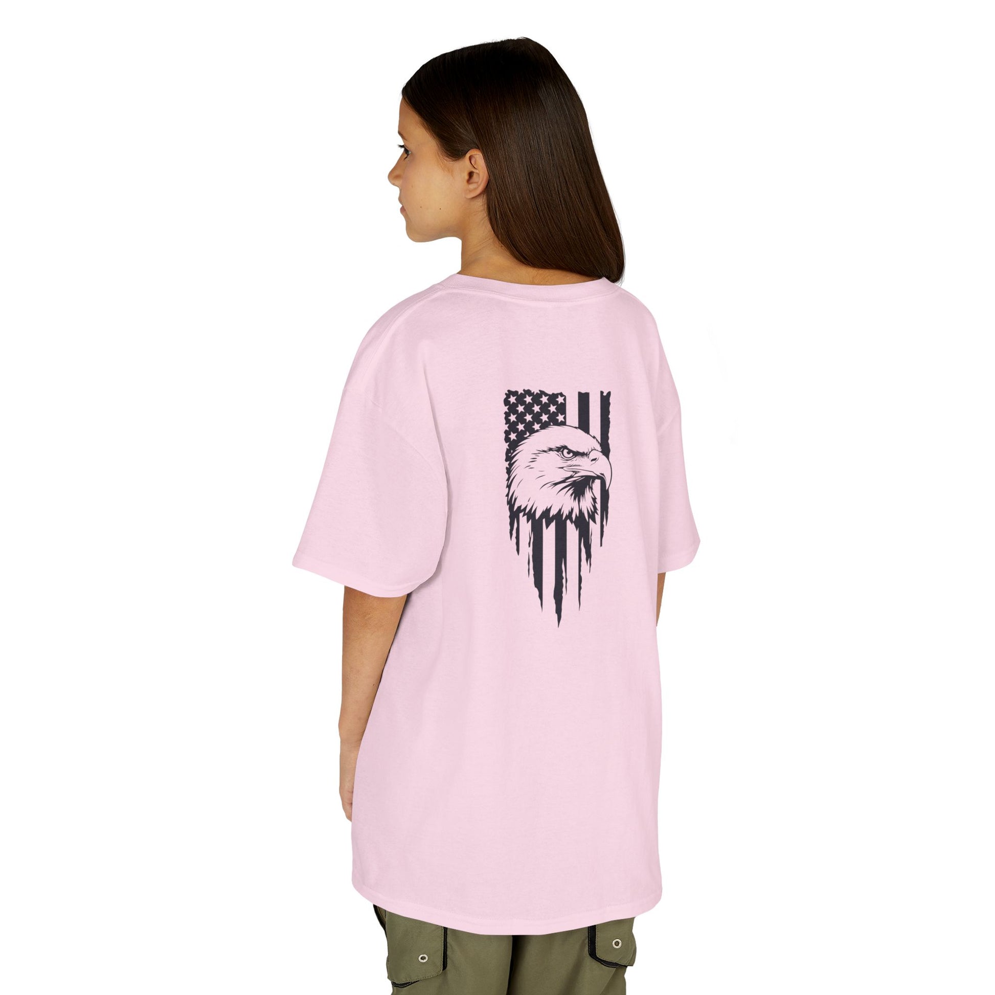 Person wearing a pink t-shirt with a graphic design on the back, standing against a white background