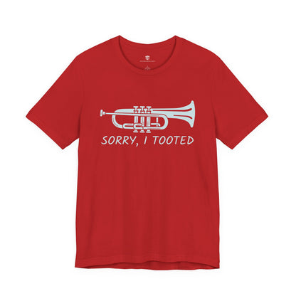 Red t-shirt with a white trumpet graphic and text 