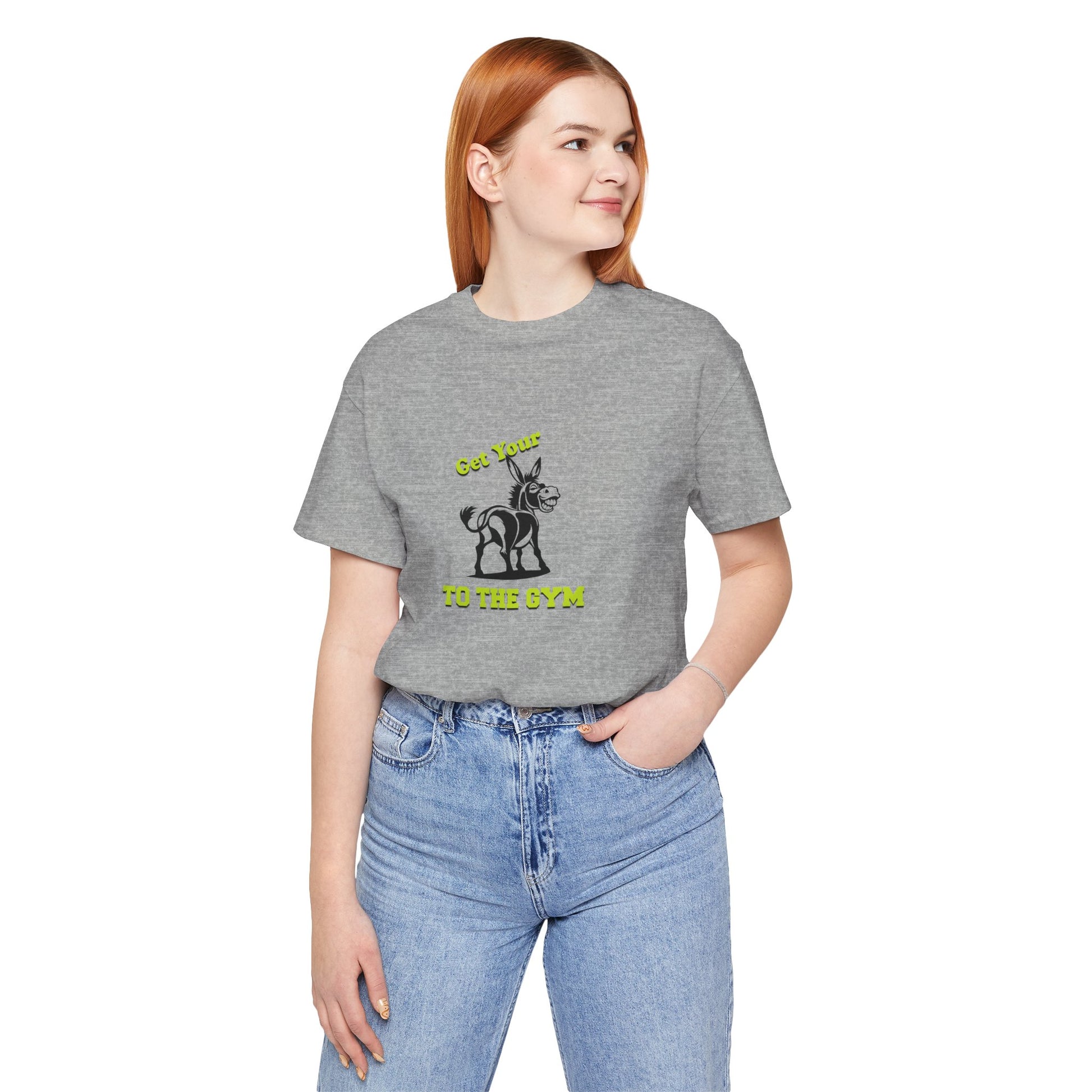 Person wearing a gray t-shirt with a logo and blue jeans on a white background