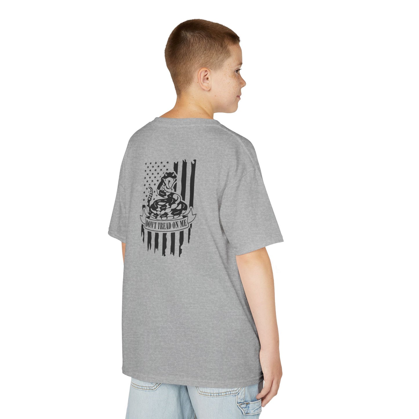 Person wearing a gray t-shirt with a graphic design on the back, standing against a white background