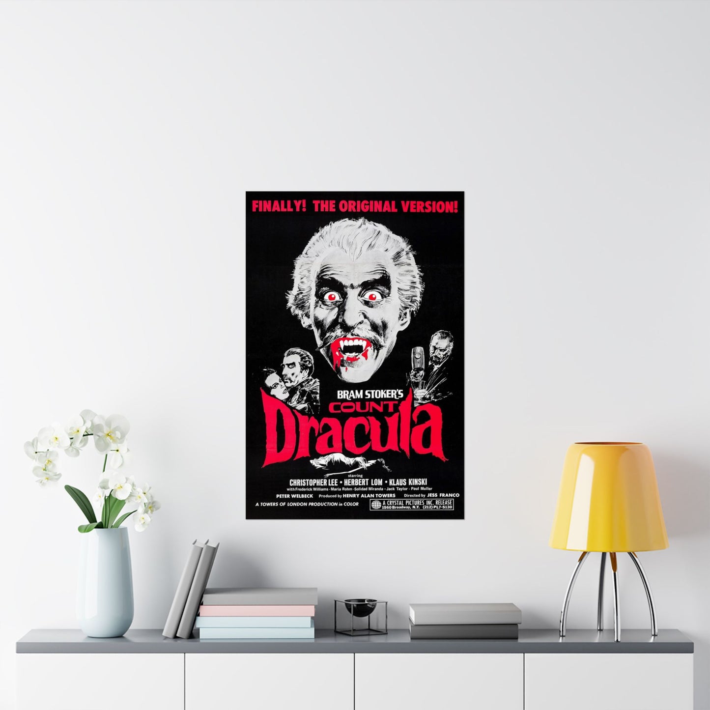 Movie poster for 'Count Dracula' on a wall above a shelf with decor items.