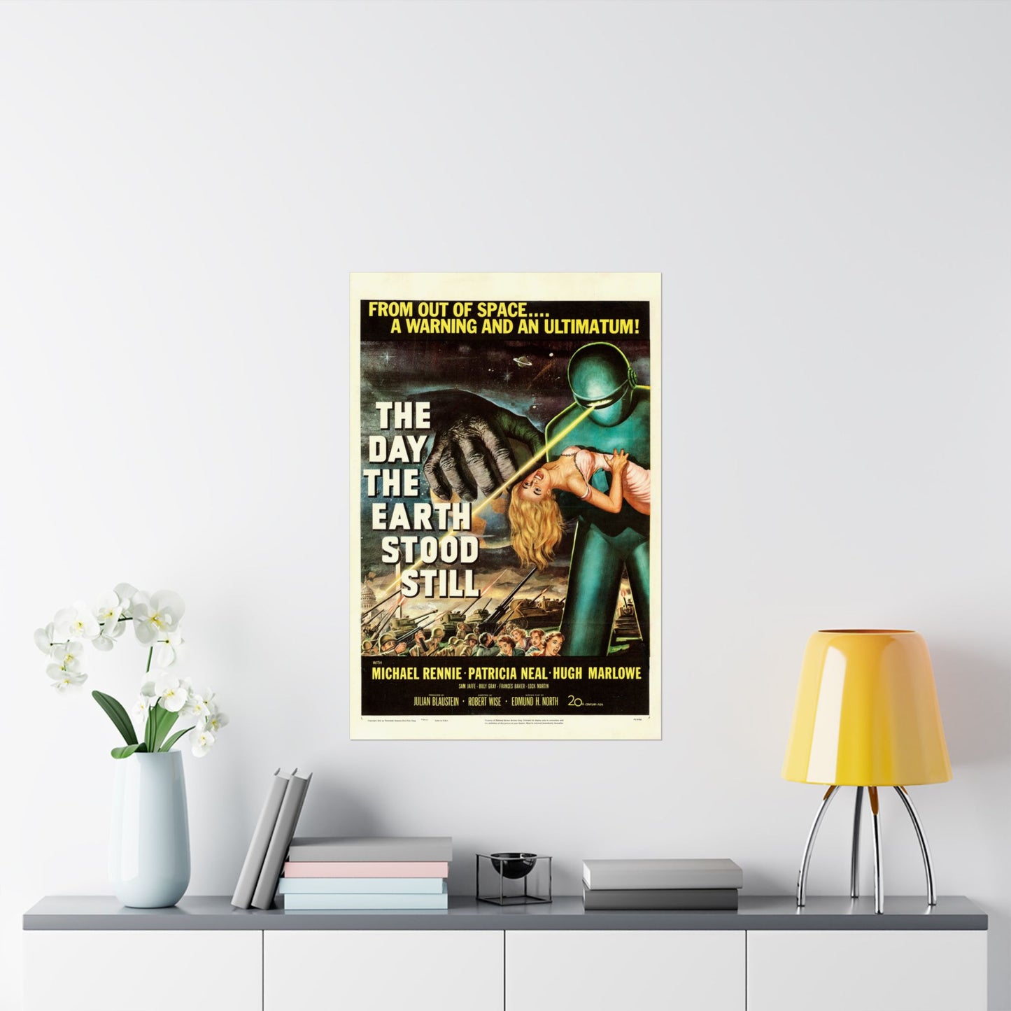 Movie poster for 'The Day the Earth Stood Still' on a wall above a shelf with decor items.