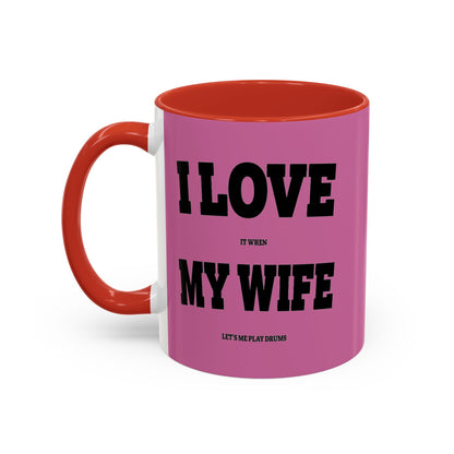 Pink mug with red interior and handle, featuring text on a white background