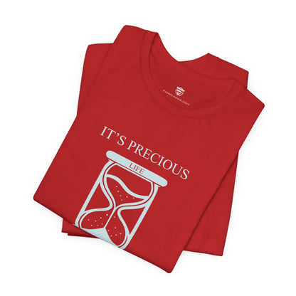 Folded red t-shirt with 'It's Precious Life' design on a white background